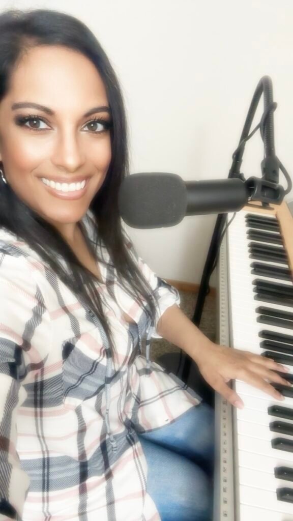 Sairaina teaching piano, voice, and guitar lessons to a student during an in home music lesson in Portland, Oregon