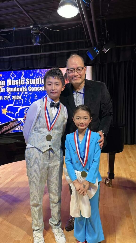 Brian Cho posing with two award-winning piano students after a student recital performance in Irvine, California.